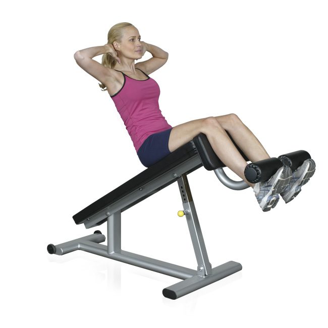 A woman doing curl ups in an adjustable decline ab bench